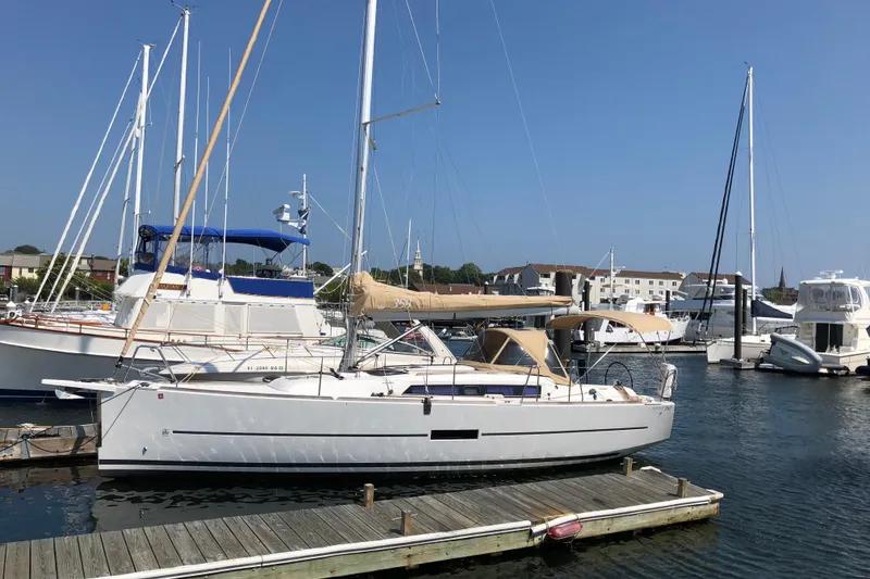The Image of 2017 Dufour 350 Grand Large sailboat docked in a marina under clear blue skies. - 1