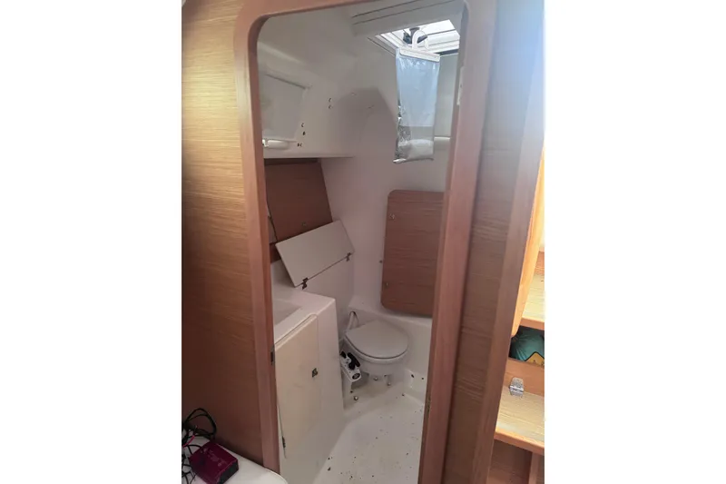 Slide: The Image of Interior of 2017 Dufour 350 Grand Large yacht bathroom with wooden accents. - 15