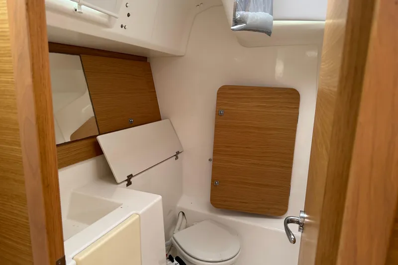 Slide: The Image of 2017 Dufour 350 Grand Large yacht bathroom with wooden accents and compact design. - 16