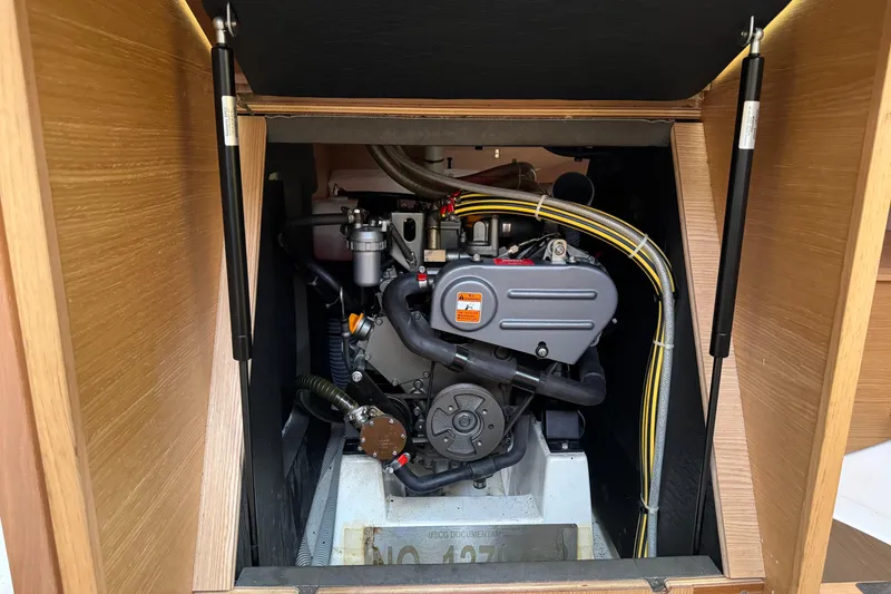 Slide: The Image of Engine compartment of a 2017 Dufour 350 Grand Large sailboat, showcasing mechanical components. - 17