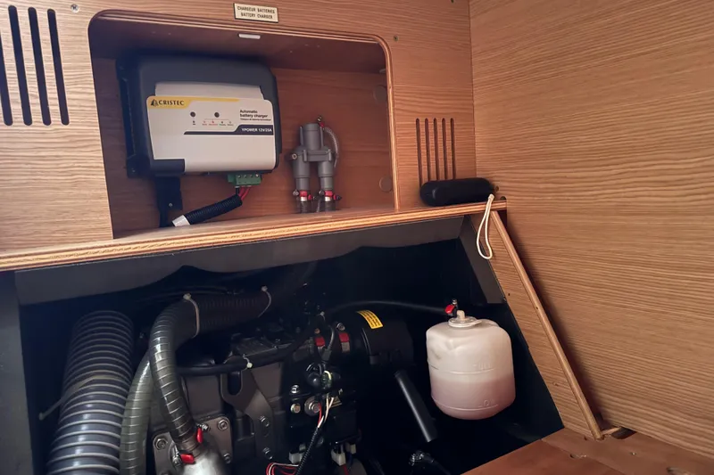 Slide: The Image of Engine compartment of 2017 Dufour 350 Grand Large yacht with battery charger and components. - 18