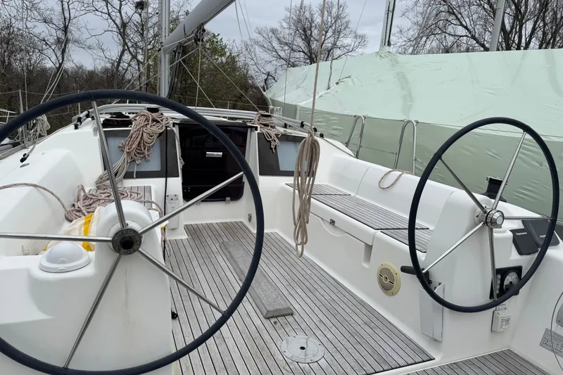 Slide: The Image of 2017 Dufour 350 Grand Large sailboat cockpit with dual steering wheels and ropes. - 6