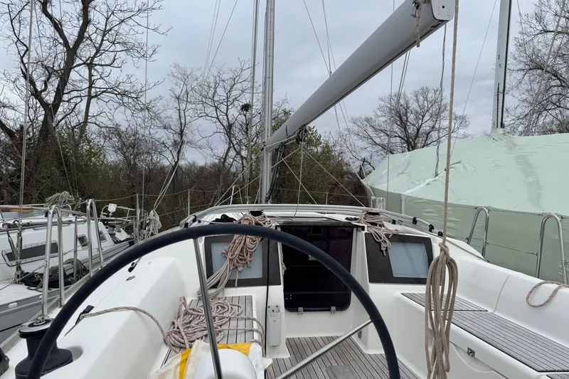Slide: The Image of 2017 Dufour 350 Grand Large sailboat cockpit with wheel and ropes, docked outdoors. - 7