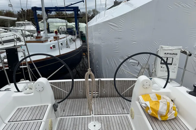 Slide: The Image of 2017 Dufour 350 Grand Large sailboat cockpit with dual steering wheels and wooden deck. - 8