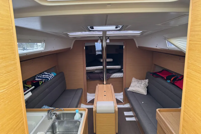 Slide: The Image of Interior of 2017 Dufour 350 Grand Large sailboat, featuring cozy seating and modern amenities. - 9
