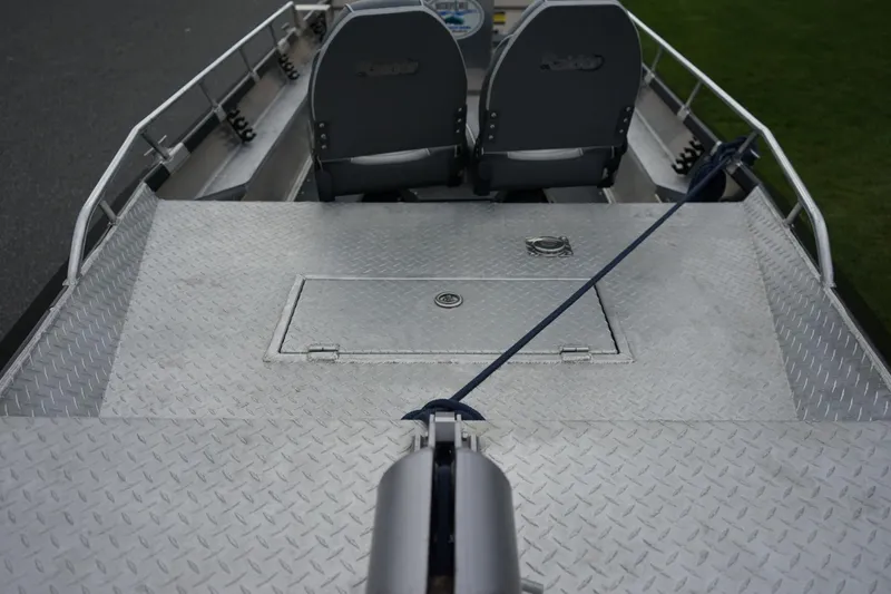 Slide: The Image of 2021 Wooldridge 16 Alaskan LT boat interior with diamond plate flooring and seating. - 12