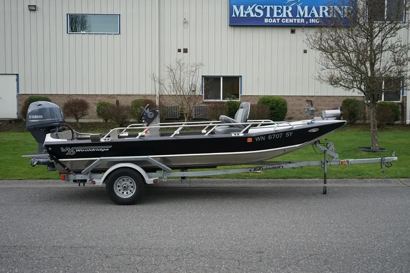 Slide: The Image of 2021 Wooldridge 16 Alaskan LT boat on trailer, parked outside Master Marine Boat Center. - 2