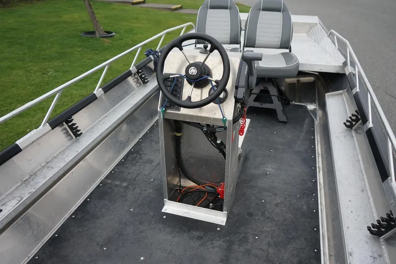 Slide: The Image of 2021 Wooldridge 16 Alaskan LT boat interior with steering console and seating. - 6