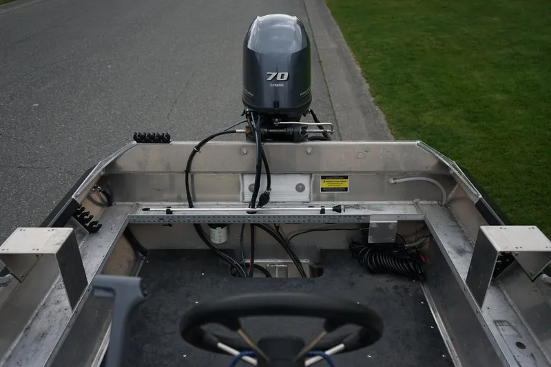 Slide: The Image of 2021 Wooldridge 16 Alaskan LT boat with Yamaha 70 outboard motor, parked on roadside. - 7