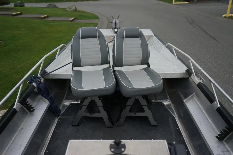 Slide: The Image of 2021 Wooldridge 16 Alaskan LT boat interior with two gray seats. - 8