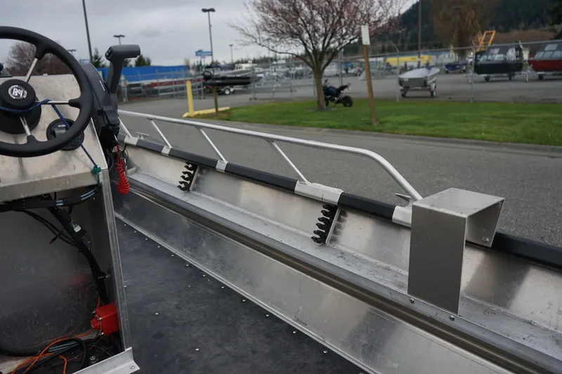 Slide: The Image of 2021 Wooldridge 16 Alaskan LT boat interior with steering wheel and metal railings. - 9
