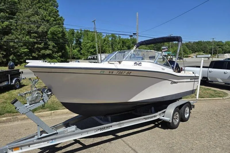 The Image of 2007 Grady-White Tournament 205 boat on trailer, parked outdoors on a sunny day. - 1