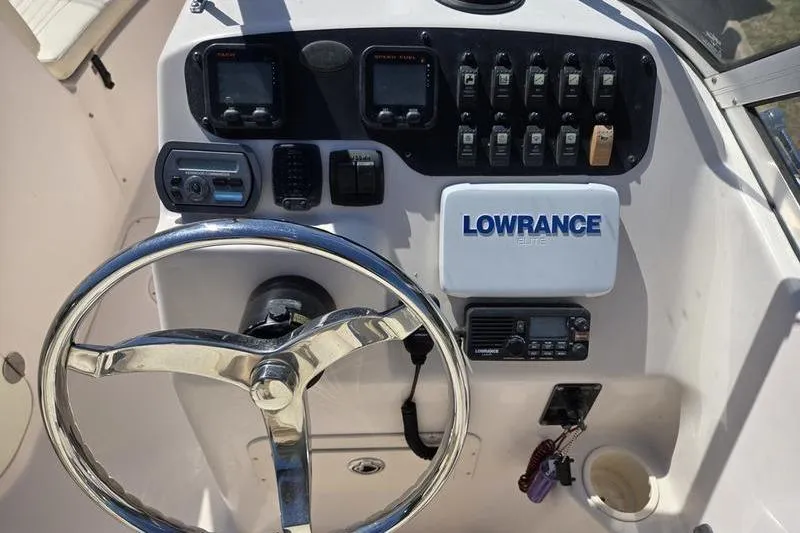 Slide: The Image of Dashboard of a 2007 Grady-White Tournament 205 boat with steering wheel and Lowrance electronics. - 10
