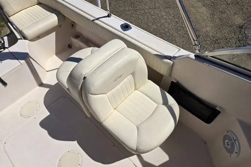 Slide: The Image of 2007 Grady-White Tournament 205 boat interior with white seating and cup holders. - 11