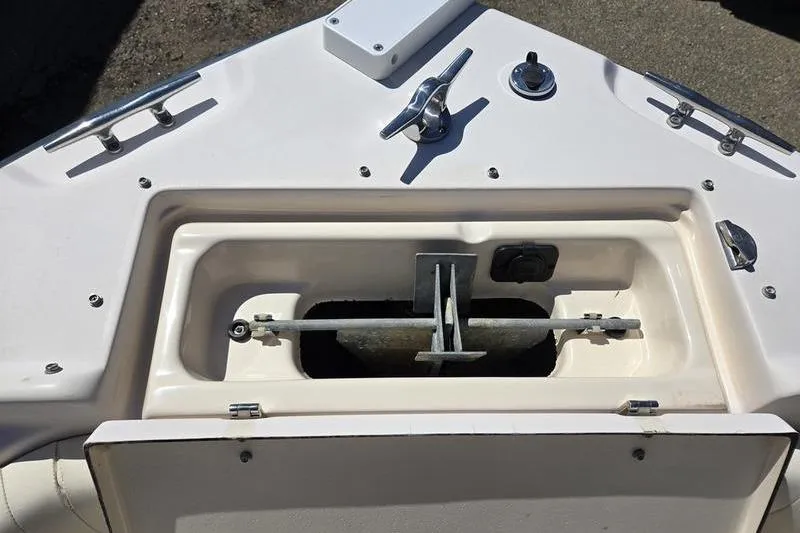 Slide: The Image of Anchor compartment of 2007 Grady-White Tournament 205 boat, featuring cleats and fittings. - 12