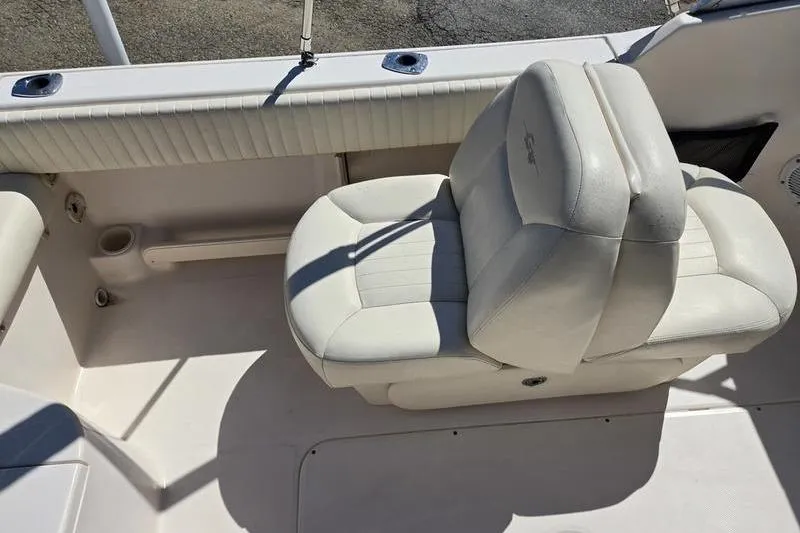 Slide: The Image of 2007 Grady-White Tournament 205 boat seat, featuring white cushioned upholstery and cup holder. - 16