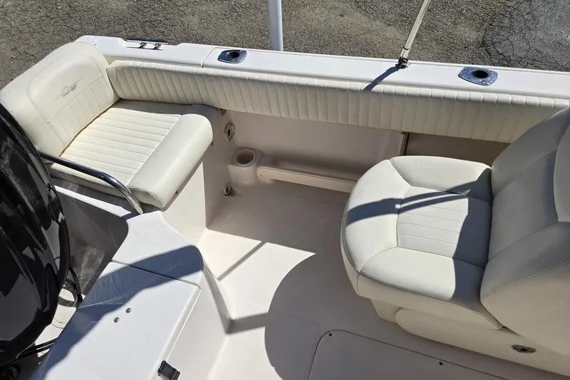 Slide: The Image of 2007 Grady-White Tournament 205 boat interior with white seating and cup holder. - 17