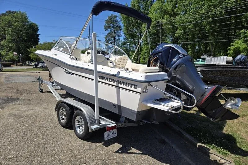 Slide: The Image of 2007 Grady-White Tournament 205 boat on trailer, parked outdoors, with outboard motor. - 3
