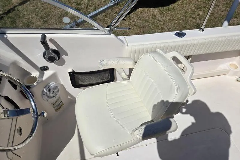 Slide: The Image of 2007 Grady-White Tournament 205 boat interior with white captain's chair and steering wheel. - 6