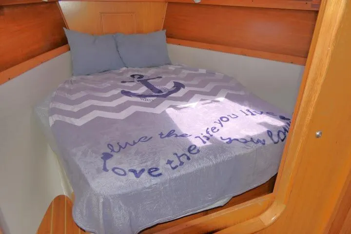 Slide: The Image of Cozy cabin bed in 2001 Catalina 310 sailboat with nautical-themed bedding. - 17