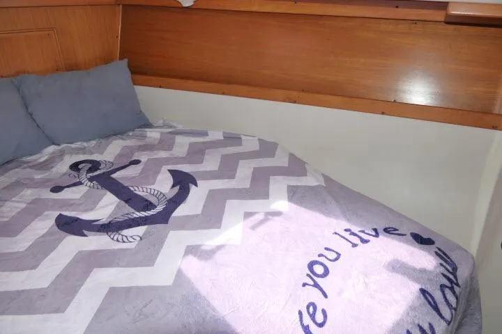Slide: The Image of Cozy cabin bed in 2001 Catalina 310 sailboat with nautical-themed bedding. - 20