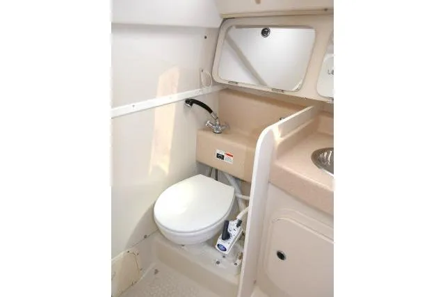 Slide: The Image of 2001 Catalina 310 boat bathroom with toilet, sink, and mirror. - 22