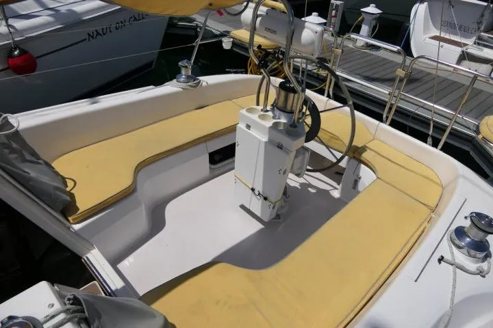 Slide: The Image of Cockpit of a 2001 Catalina 310 sailboat with yellow seating and steering equipment. - 25