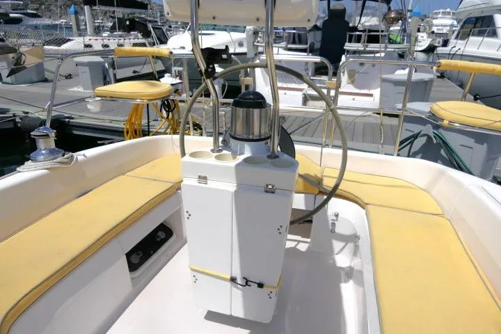 Slide: The Image of Cockpit of a 2001 Catalina 310 sailboat with yellow seating and steering wheel. - 26