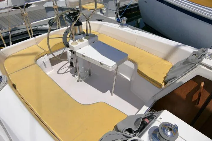 Slide: The Image of Cockpit of a 2001 Catalina 310 sailboat with yellow seating and steering wheel. - 28