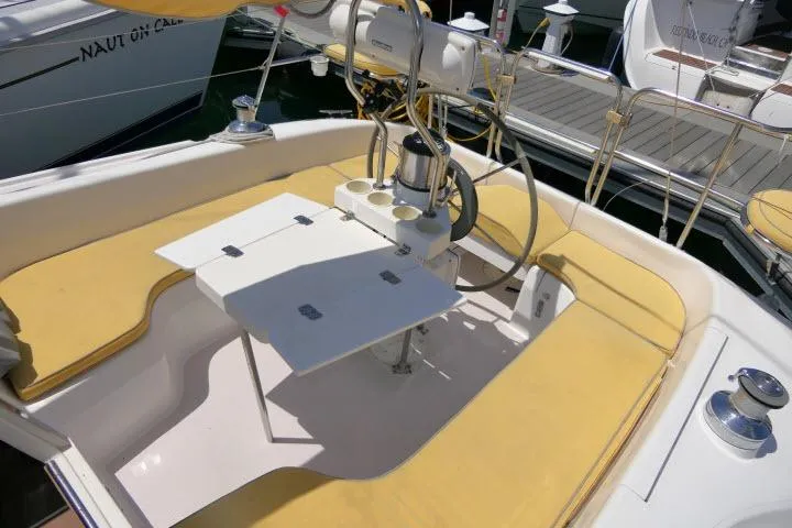 Slide: The Image of Cockpit of 2001 Catalina 310 sailboat with yellow seating and foldable table. - 30