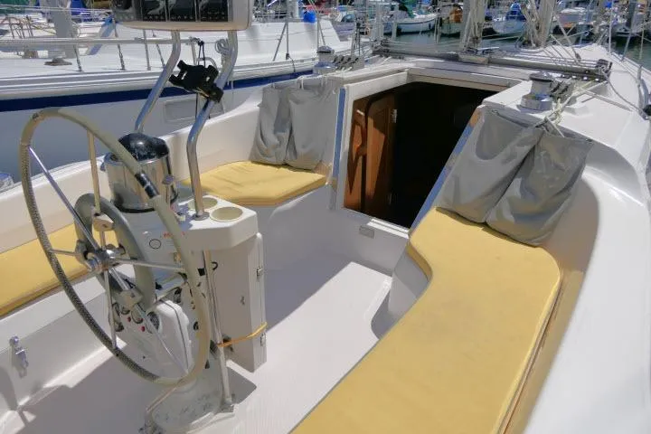 Slide: The Image of Cockpit of 2001 Catalina 310 sailboat with yellow cushions and steering wheel. - 31