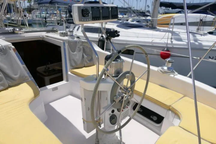 Slide: The Image of Cockpit of a 2001 Catalina 310 sailboat with steering wheel and navigation instruments. - 32