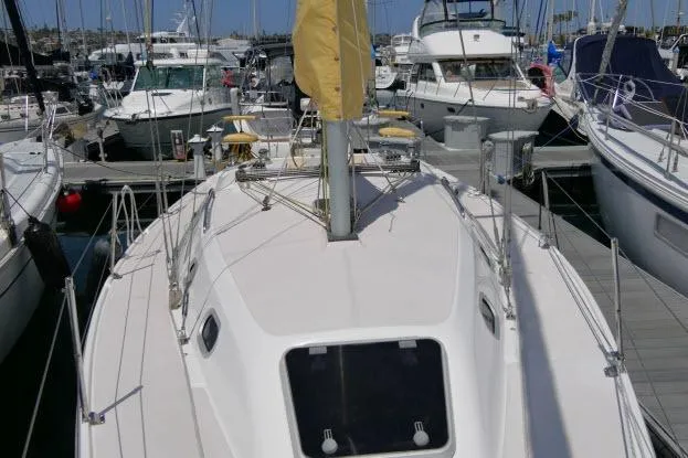 Slide: The Image of Catalina 310 sailboat from 2001 docked at a marina, surrounded by other boats. - 36