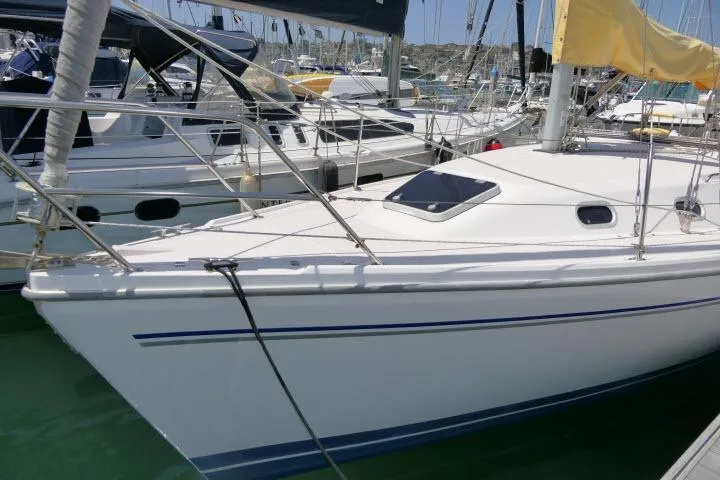 Slide: The Image of 2001 Catalina 310 sailboat docked in a marina, featuring sleek white hull and deck. - 38