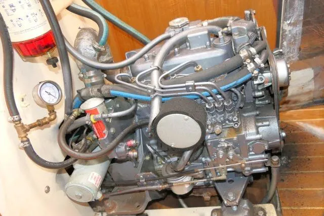Slide: The Image of Engine of a 2001 Catalina 310 sailboat, showcasing intricate mechanical components and hoses. - 42