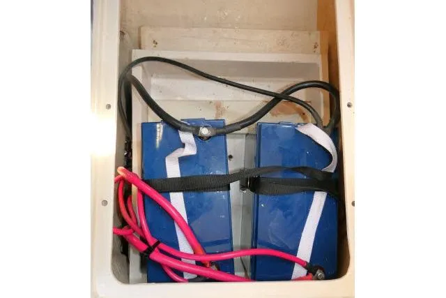 Slide: The Image of Two blue marine batteries with red cables in a 2001 Catalina 310 boat. - 43