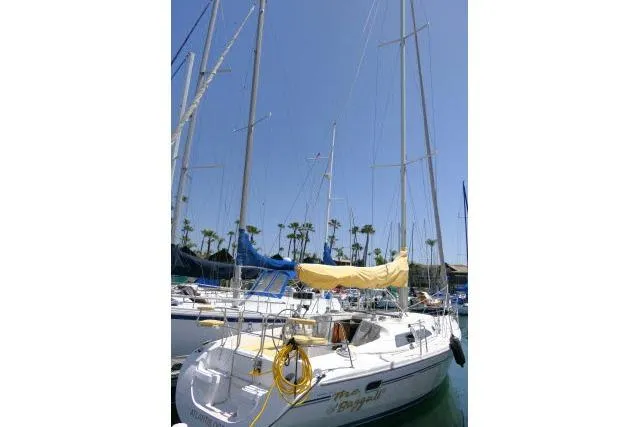 Slide: The Image of 2001 Catalina 310 sailboat docked in marina with clear blue sky. - 47