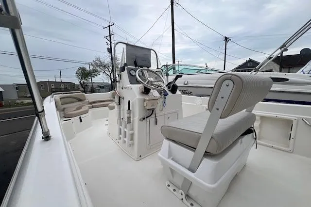Slide: The Image of 2013 NauticStar 210 Coastal boat interior with steering console and seating. - 4