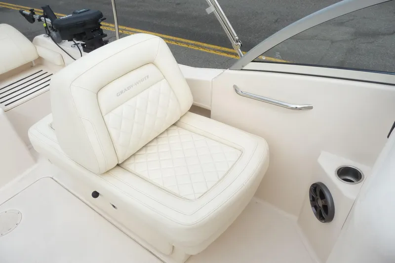 Slide: The Image of 2021 Grady-White Freedom 215 boat interior with white cushioned seating. - 12