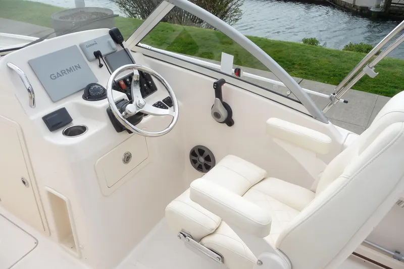 Slide: The Image of 2021 Grady-White Freedom 215 boat helm with Garmin navigation system and plush seating. - 13