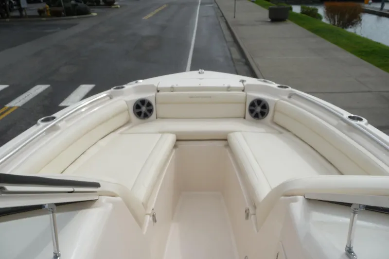 Slide: The Image of 2021 Grady-White Freedom 215 boat interior with white seating and speakers. - 15