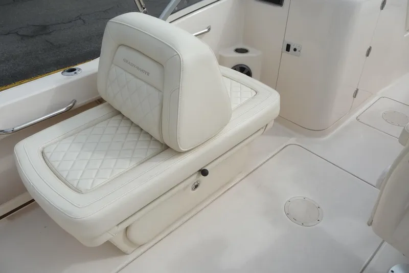 Slide: The Image of 2021 Grady-White Freedom 215 boat interior with white cushioned seating. - 17