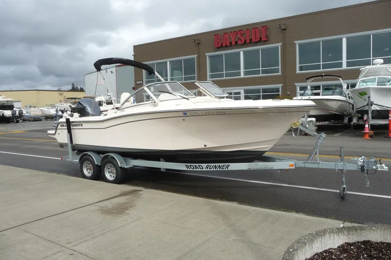 Slide: The Image of 2021 Grady-White Freedom 215 boat on trailer outside Bayside dealership. - 2