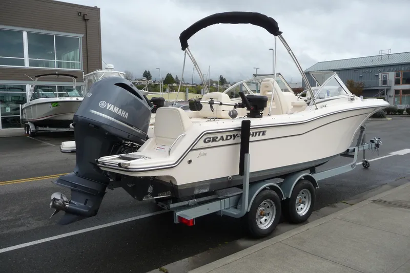 Slide: The Image of 2021 Grady-White Freedom 215 boat with Yamaha engine on trailer, parked outdoors. - 5