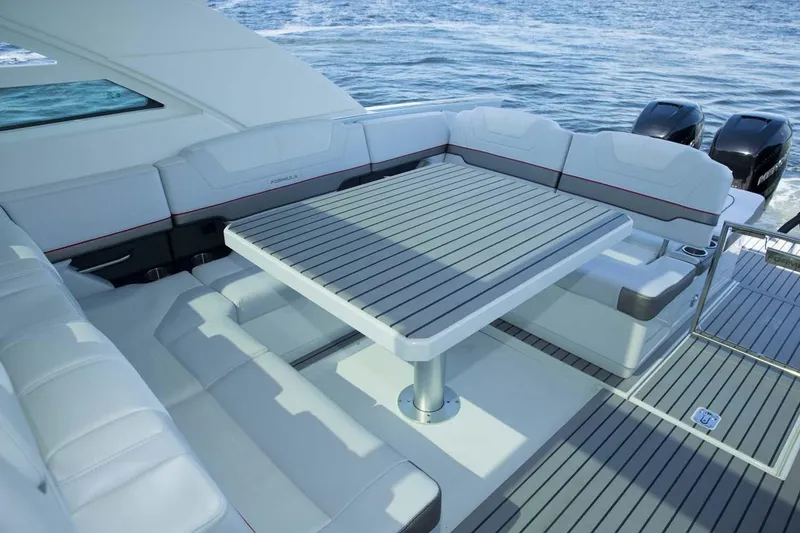 Slide: The Image of Manufacturer Provided Image: 2019 Formula 430 Super Sport Crossover boat with spacious seating and table on deck. - 13