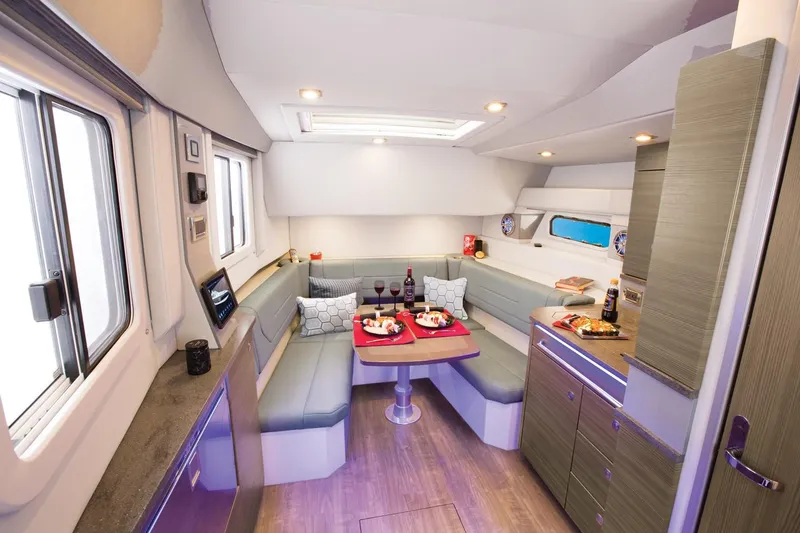 Slide: The Image of Manufacturer Provided Image: 2019 Formula 430 Super Sport Crossover interior dining area with modern seating and table setup. - 18