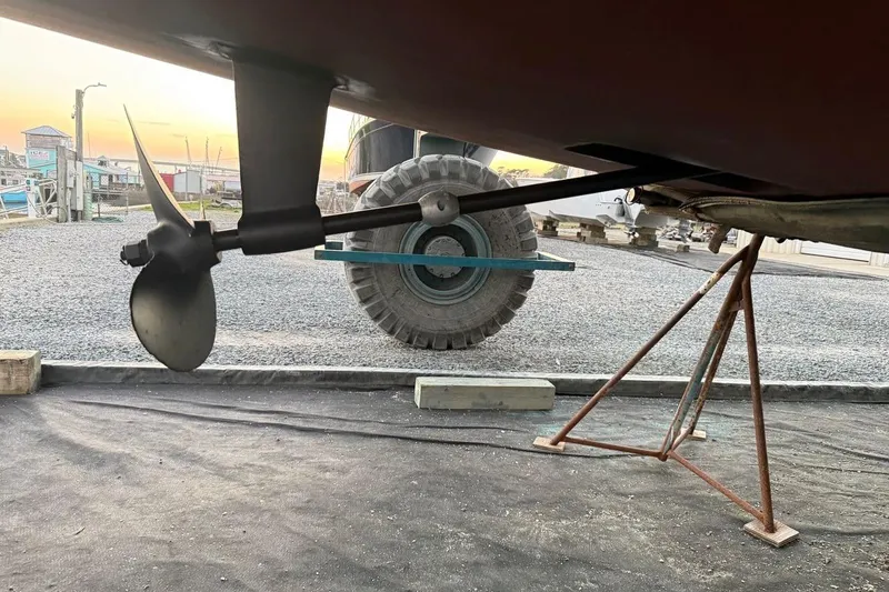 Slide: The Image of Propeller and shaft of a 2009 Hunter 38 sailboat on a stand at sunset. - 10
