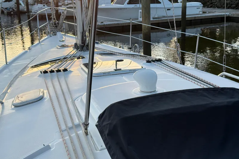 Slide: The Image of 2009 Hunter 38 sailboat deck with ropes and marina background. - 23