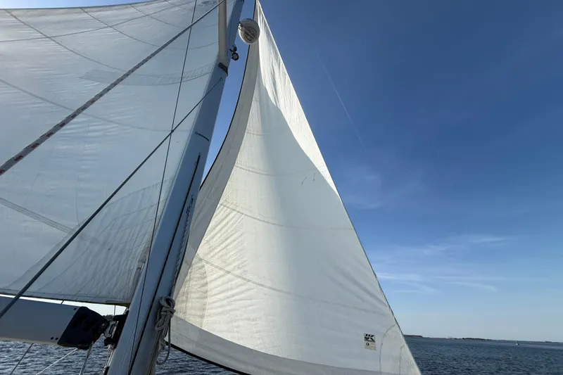 Slide: The Image of Sailing on a 2009 Hunter 38 yacht with white sails against a clear blue sky. - 30