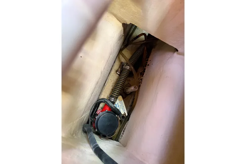 Slide: The Image of Bilge area of a 2009 Hunter 38 sailboat showing pump and wiring. - 32